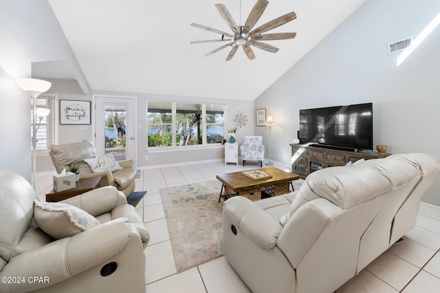 living room featuring ceiling fan, light tile patterned flooring, and high vaulted ceiling