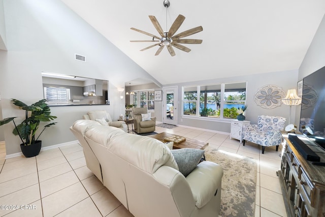 living room with ceiling fan, high vaulted ceiling, and light tile patterned floors