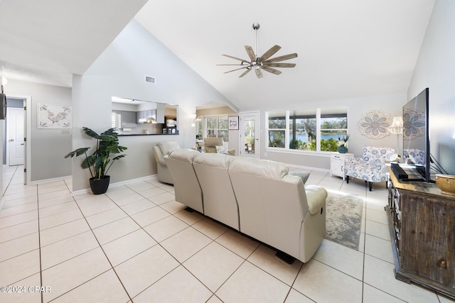 tiled living room with ceiling fan and lofted ceiling