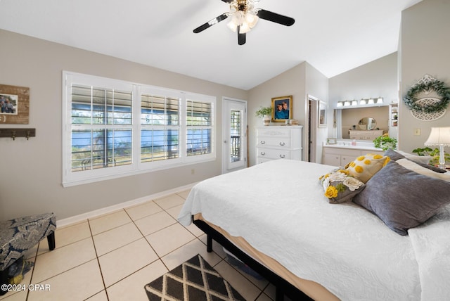 tiled bedroom with ensuite bathroom, ceiling fan, and vaulted ceiling