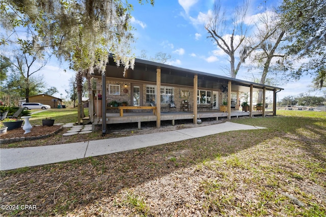 exterior space featuring a porch and a lawn