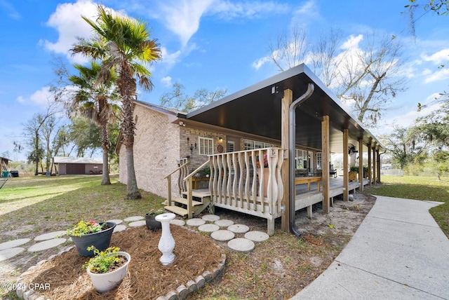 view of home's exterior featuring a lawn and a deck