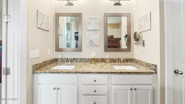 full bath with a sink and double vanity