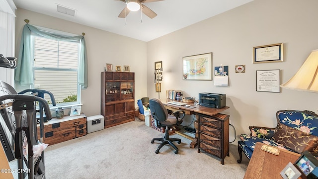 carpeted office space with ceiling fan and visible vents