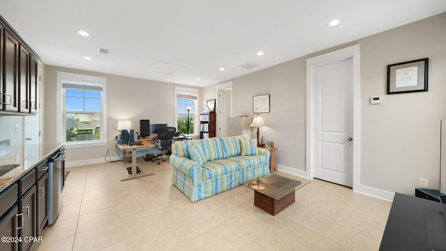 living room featuring baseboards, light tile patterned floors, visible vents, and recessed lighting