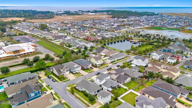 drone / aerial view with a residential view and a water view