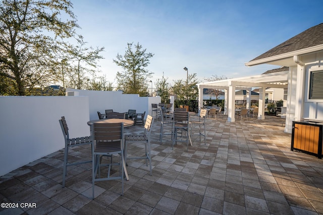 view of patio / terrace featuring outdoor dining space, fence, and a pergola