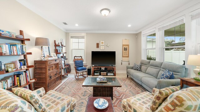 living room featuring ornamental molding and light wood-type flooring