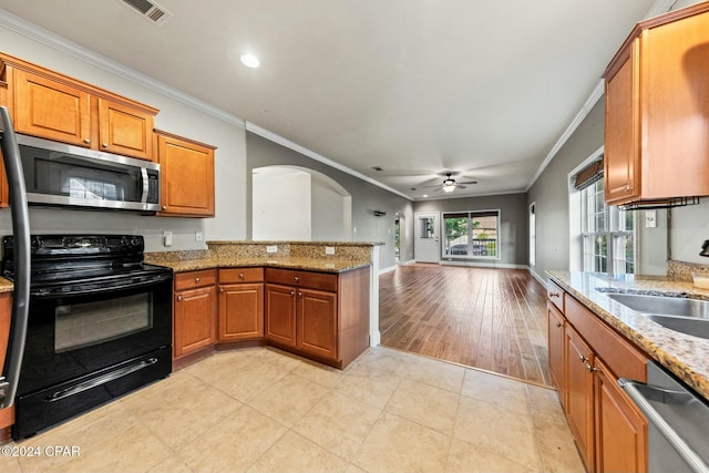 kitchen featuring stainless steel appliances, ceiling fan, crown molding, and sink