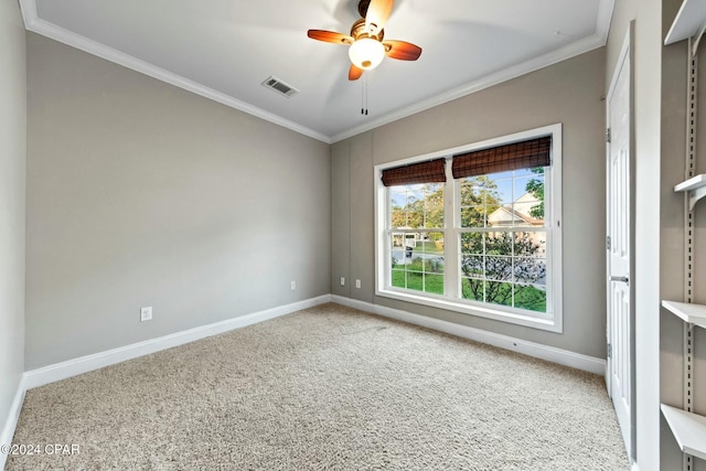 carpeted empty room featuring ceiling fan and crown molding