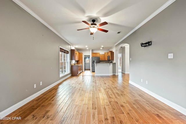 unfurnished living room featuring light hardwood / wood-style floors, ceiling fan, and crown molding