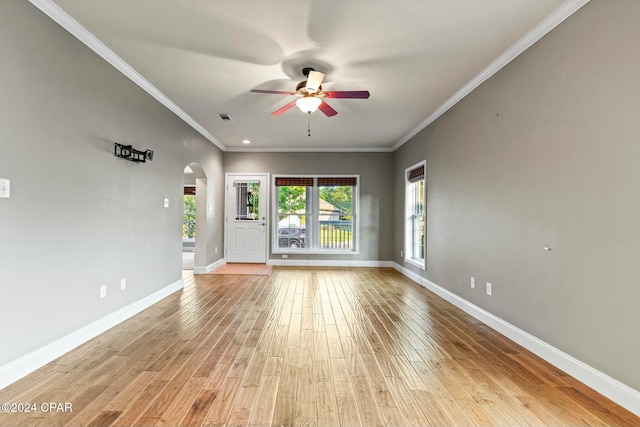 empty room with ceiling fan, light hardwood / wood-style flooring, and ornamental molding