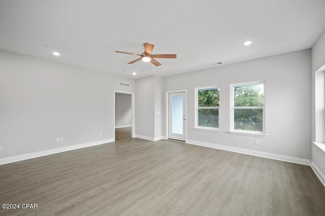 unfurnished room with hardwood / wood-style floors and ceiling fan