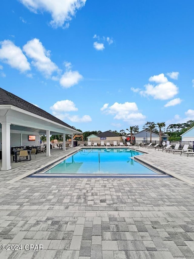 view of swimming pool with a patio area