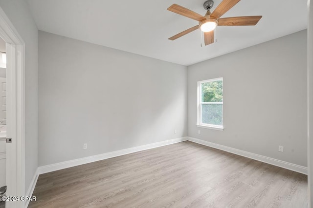 empty room with ceiling fan and light hardwood / wood-style flooring