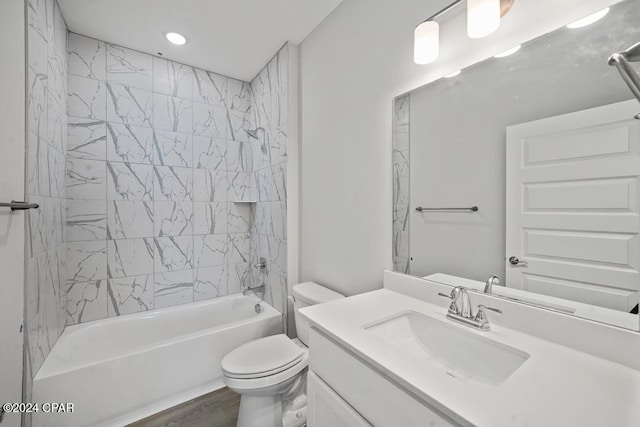 full bathroom featuring vanity, hardwood / wood-style floors, toilet, and tiled shower / bath