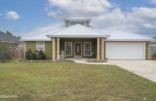 4713 Shannon Ln, Panama City, FL 32404 - view of front of home with a garage, concrete driveway, metal roof, stucco siding, and covered porch