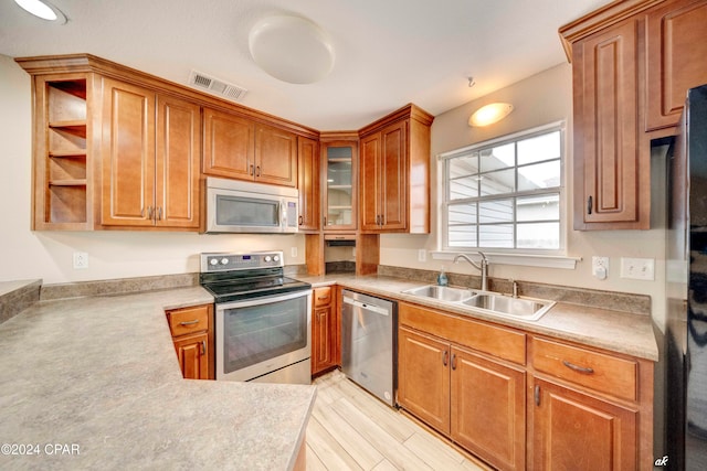 kitchen featuring light hardwood / wood-style floors, sink, and stainless steel appliances