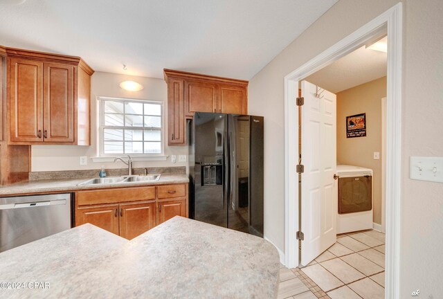 kitchen featuring dishwasher, black fridge with ice dispenser, light tile patterned floors, and sink