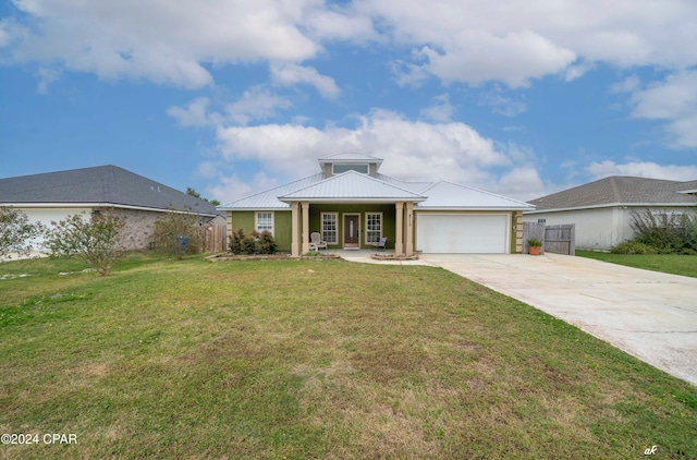 view of front of house featuring a front yard, a porch, and a garage