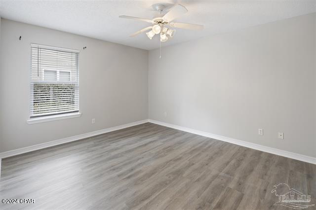 unfurnished room featuring hardwood / wood-style floors and ceiling fan