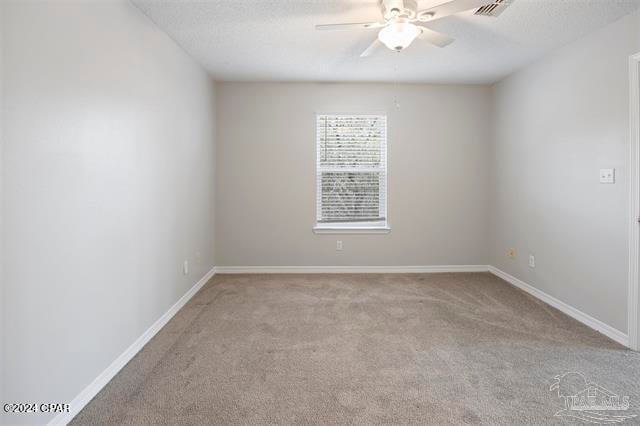 unfurnished room featuring light colored carpet and ceiling fan