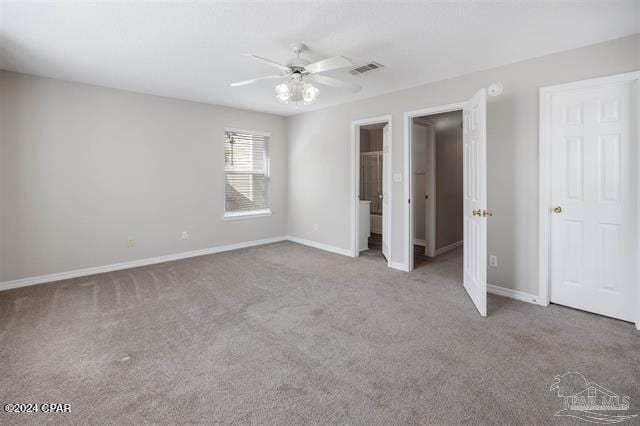 unfurnished bedroom featuring carpet, ceiling fan, and ensuite bath