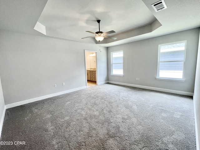 1202 Primrose Ln, Panama City, FL 32404 - carpeted spare room featuring baseboards, a ceiling fan, and a raised ceiling