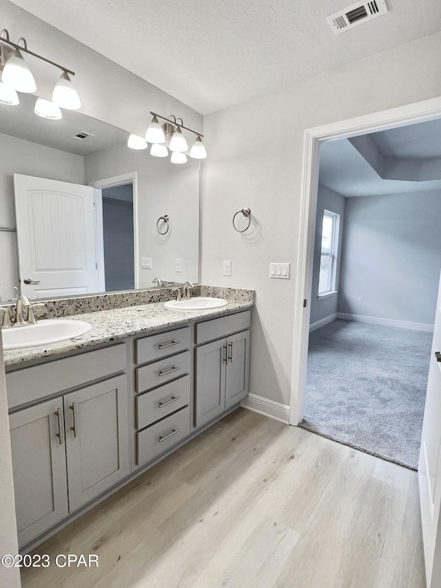 1202 Primrose Ln, Panama City, FL 32404 - bathroom featuring double vanity, wood finished floors, and baseboards