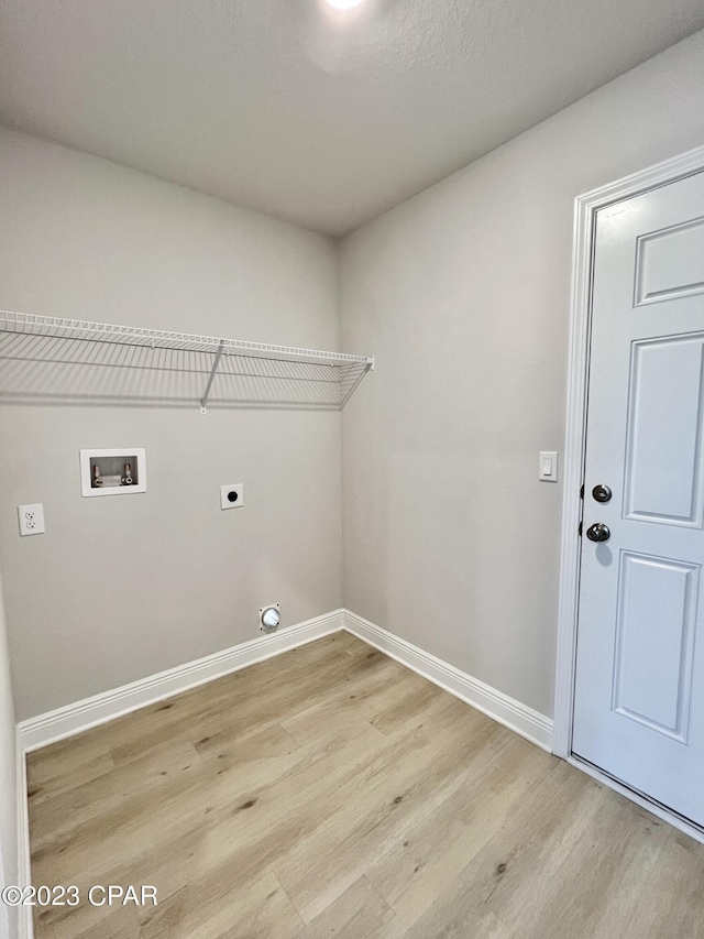 1202 Primrose Ln, Panama City, FL 32404 - washroom featuring light wood finished floors, baseboards, electric dryer hookup, and hookup for a washing machine