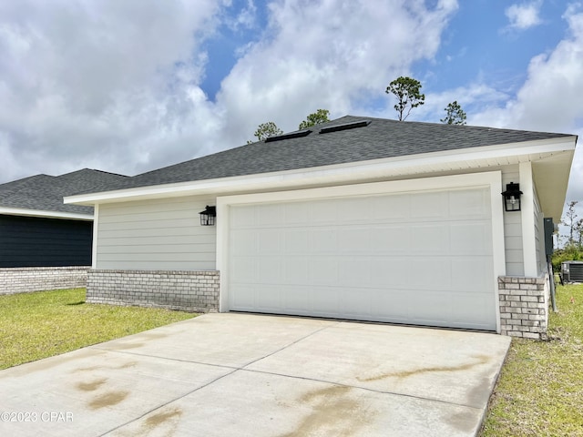 1202 Primrose Ln, Panama City, FL 32404 - garage featuring concrete driveway and central AC unit