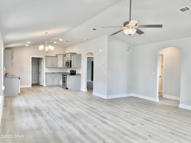 1202 Primrose Ln, Panama City, FL 32404 - unfurnished living room with arched walkways, vaulted ceiling, ceiling fan, baseboards, and a sink