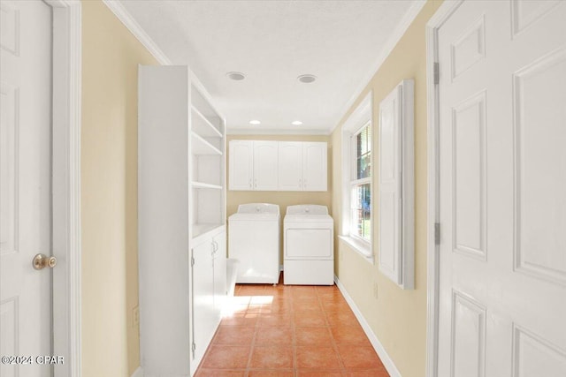 clothes washing area featuring cabinet space, washing machine and dryer, crown molding, and light tile patterned flooring