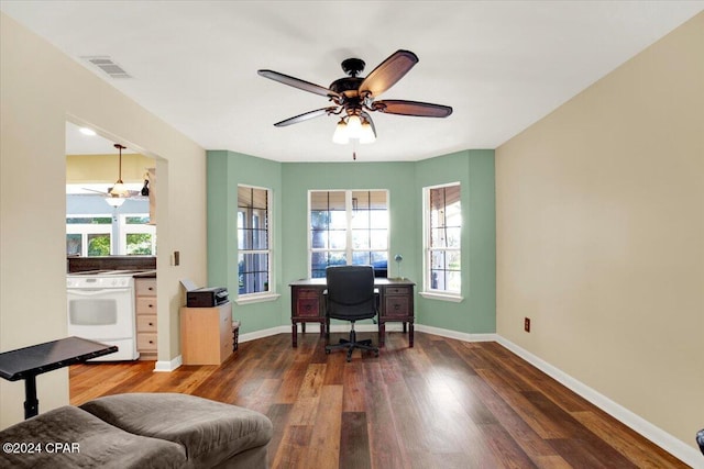 office space with wood finished floors, visible vents, and baseboards