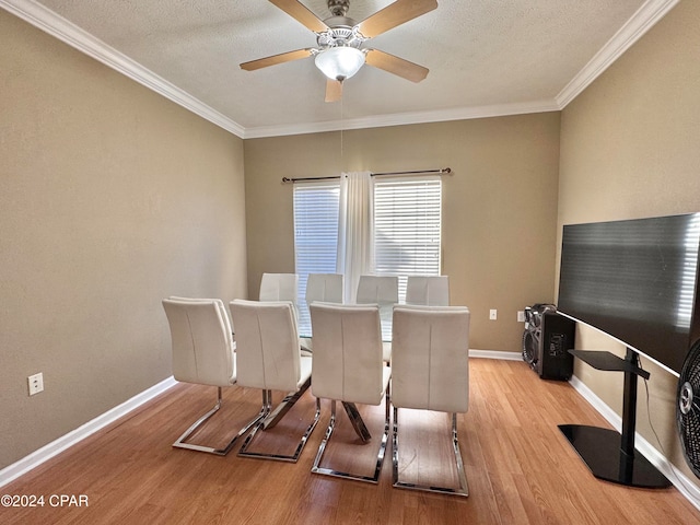 dining area featuring ceiling fan, light hardwood / wood-style floors, ornamental molding, and a textured ceiling