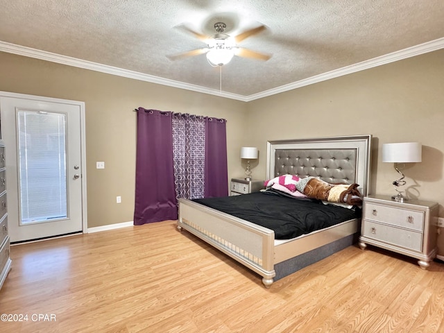 bedroom featuring a textured ceiling, light hardwood / wood-style floors, ceiling fan, and ornamental molding