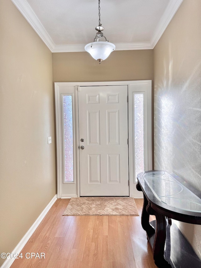 foyer with light hardwood / wood-style flooring and ornamental molding