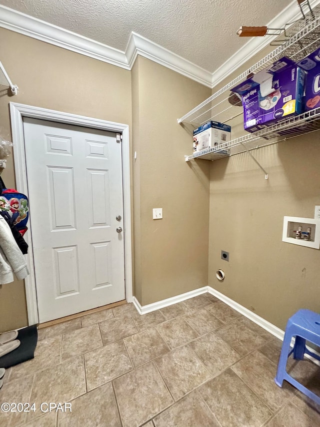 laundry area featuring ornamental molding, a textured ceiling, hookup for a washing machine, and electric dryer hookup