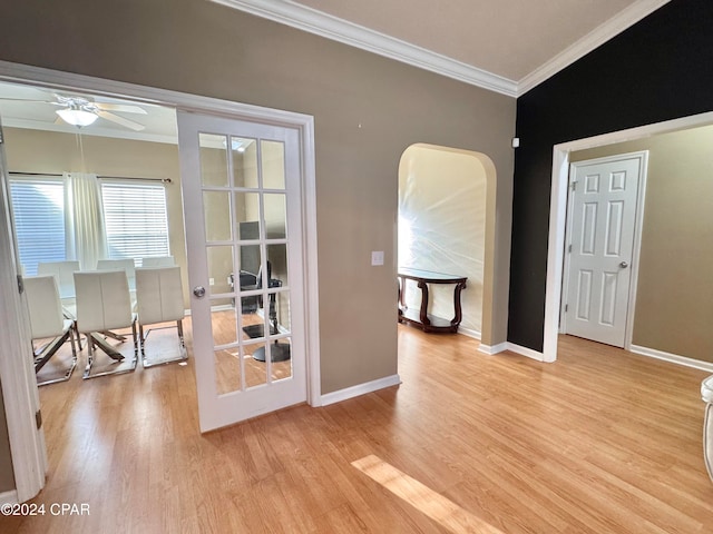 interior space with light hardwood / wood-style flooring, ceiling fan, and ornamental molding