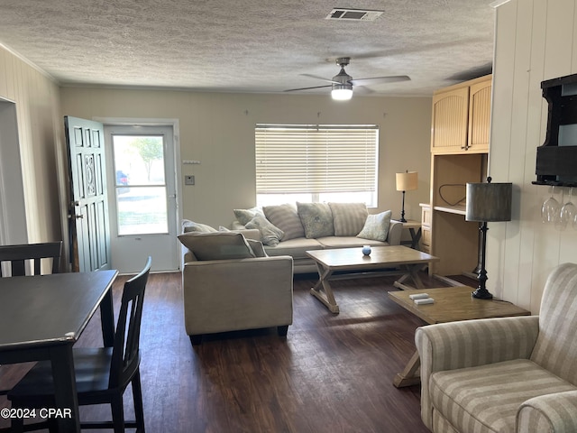 living room with ceiling fan and dark hardwood / wood-style floors