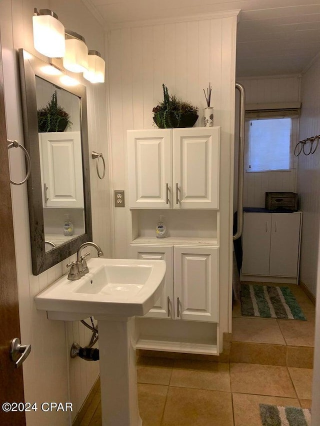 bathroom featuring tile patterned floors and wooden walls