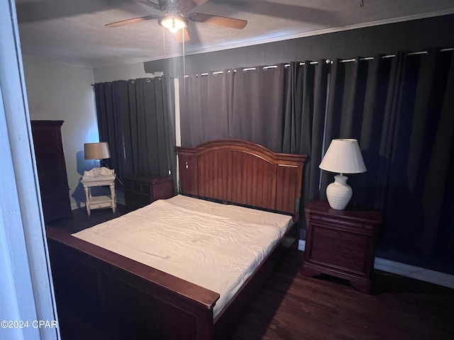 bedroom with ceiling fan and dark hardwood / wood-style floors