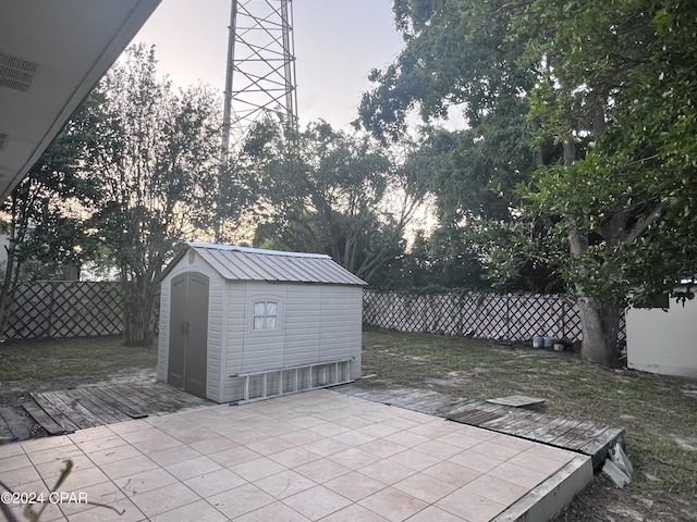 view of patio / terrace featuring a storage shed