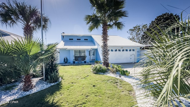 view of front of home with a front lawn and a garage