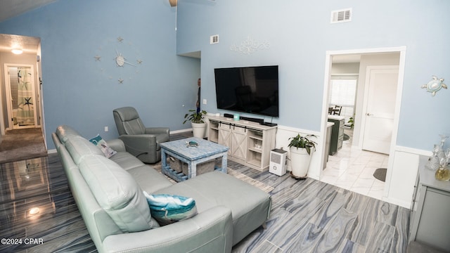 living room featuring high vaulted ceiling