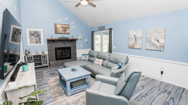 living room featuring a stone fireplace, ceiling fan, and high vaulted ceiling