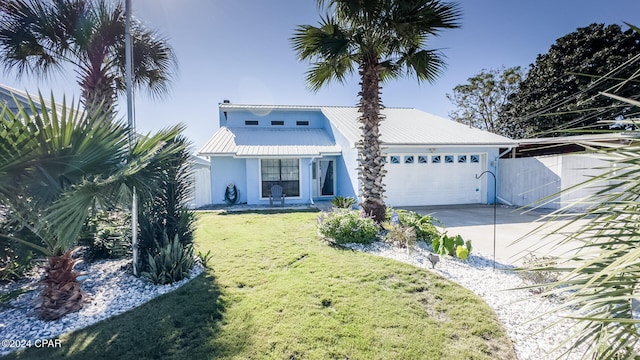 view of front of house with a garage and a front lawn