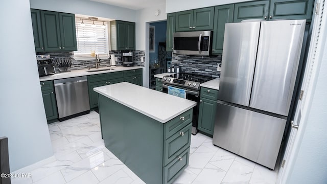 kitchen with appliances with stainless steel finishes, tasteful backsplash, sink, green cabinetry, and a center island