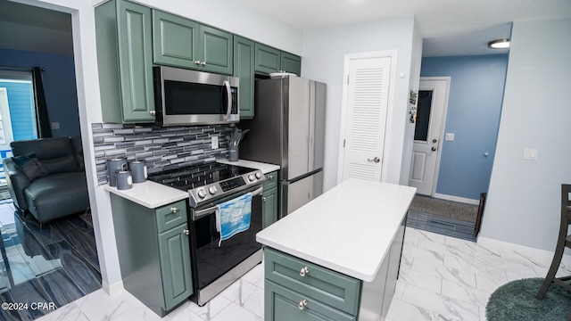 kitchen featuring green cabinets, backsplash, and appliances with stainless steel finishes