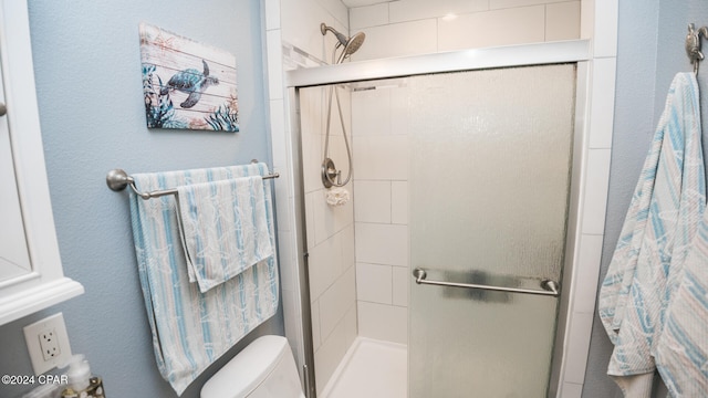 bathroom featuring an enclosed shower and toilet